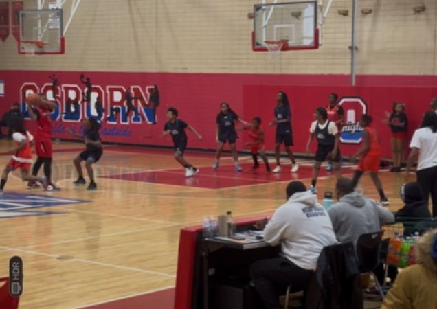 Students playing basketball in a high school gym